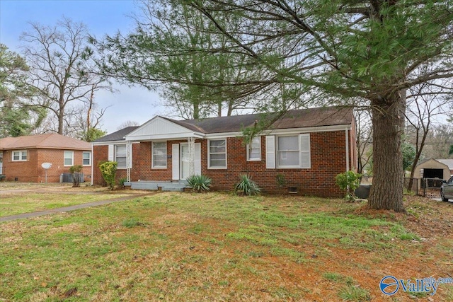 view of front facade with a front lawn and brick siding