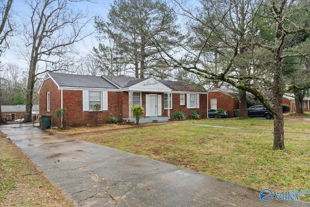 ranch-style home with brick siding and a front lawn