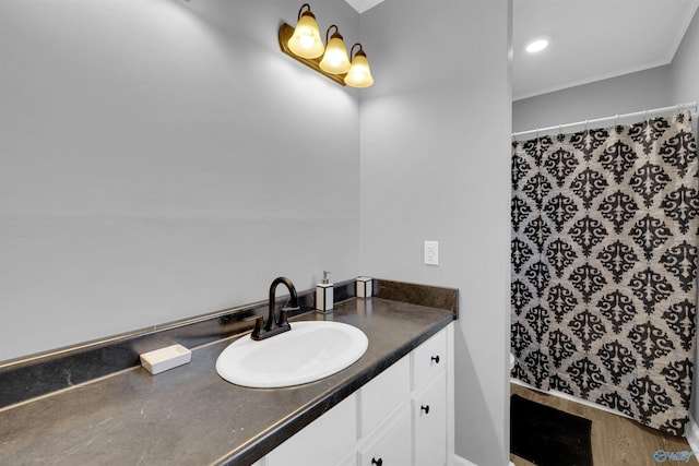 bathroom with crown molding, vanity, and curtained shower