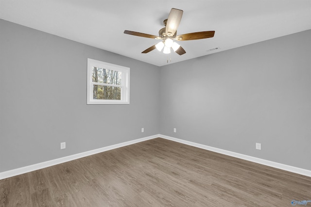 empty room with hardwood / wood-style flooring and ceiling fan