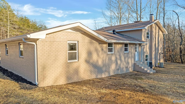 view of property exterior with central AC