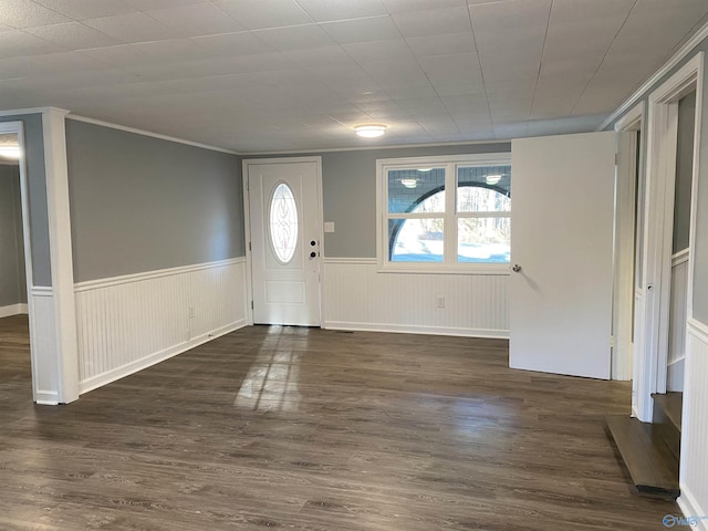 foyer with crown molding and dark wood-type flooring