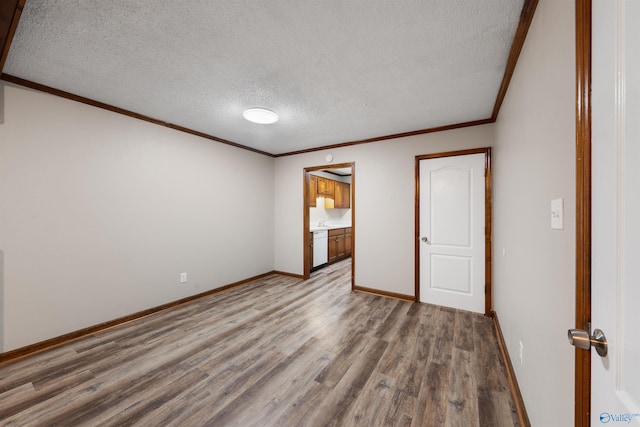 unfurnished bedroom featuring baseboards, wood finished floors, ornamental molding, and a textured ceiling