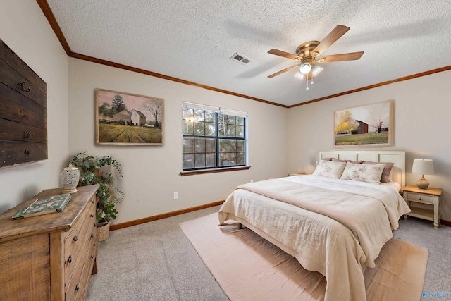 bedroom featuring ornamental molding, baseboards, a textured ceiling, visible vents, and light carpet