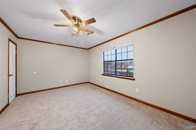 spare room with crown molding, carpet flooring, baseboards, a textured ceiling, and a ceiling fan