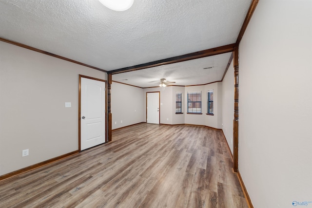 empty room featuring light wood-type flooring, ceiling fan, and a textured ceiling