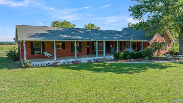 ranch-style house with covered porch and a front yard