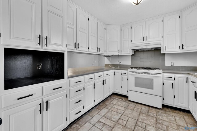 kitchen featuring stainless steel dishwasher, backsplash, tile counters, gas range gas stove, and white cabinets