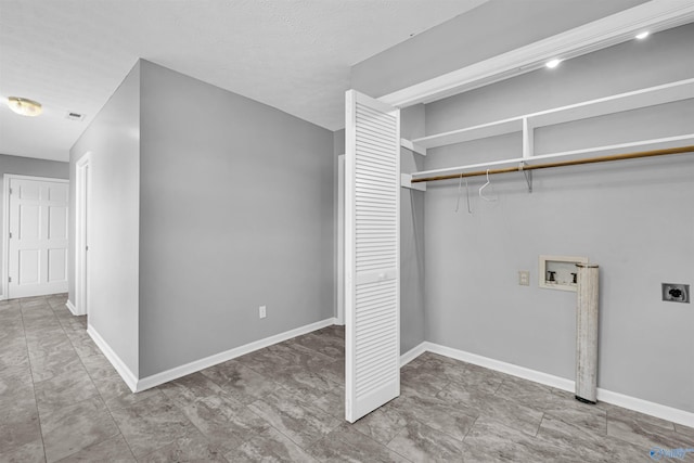 clothes washing area featuring tile patterned floors, electric dryer hookup, and washer hookup