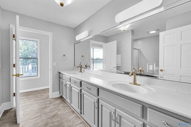 bathroom with tile patterned flooring, vanity, and a shower with shower door