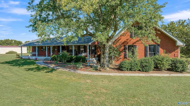 view of front of home with brick siding, a front lawn, and a porch