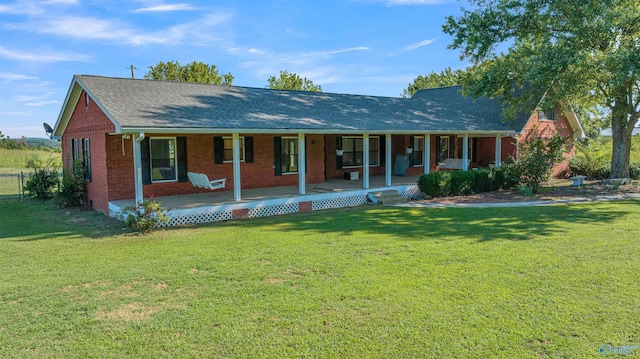 ranch-style house with a front yard and covered porch