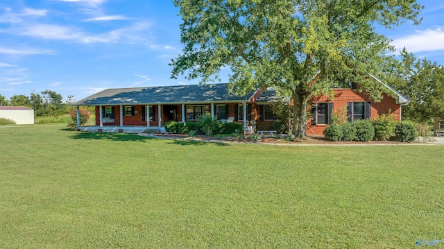 ranch-style house with a front yard and covered porch