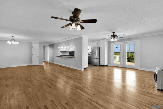 living room featuring light hardwood / wood-style flooring, french doors, crown molding, a textured ceiling, and ceiling fan with notable chandelier