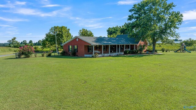 exterior space with a playground and a lawn