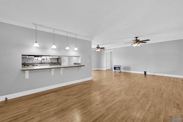 kitchen with white range with gas stovetop, light tile patterned floors, stainless steel fridge, crown molding, and white cabinets