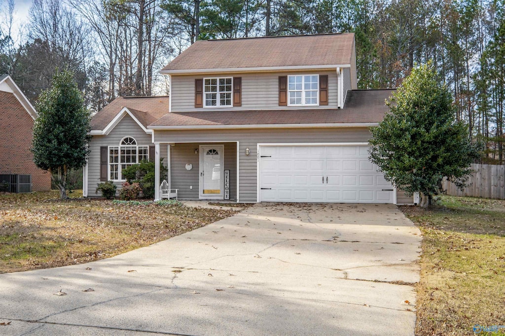 traditional-style house featuring driveway and a garage