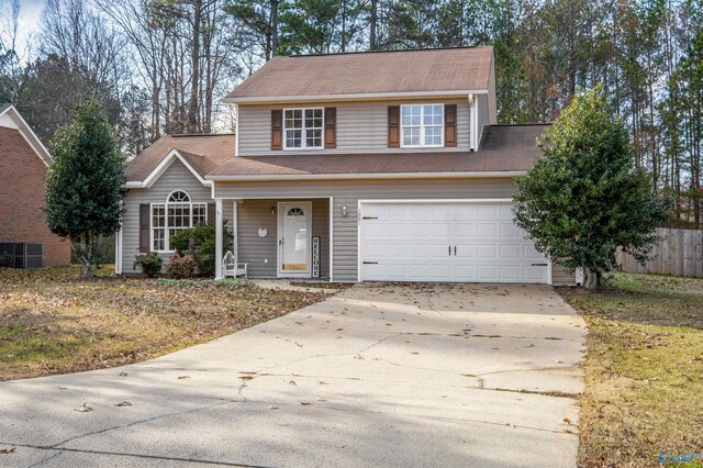 traditional-style house featuring driveway and a garage