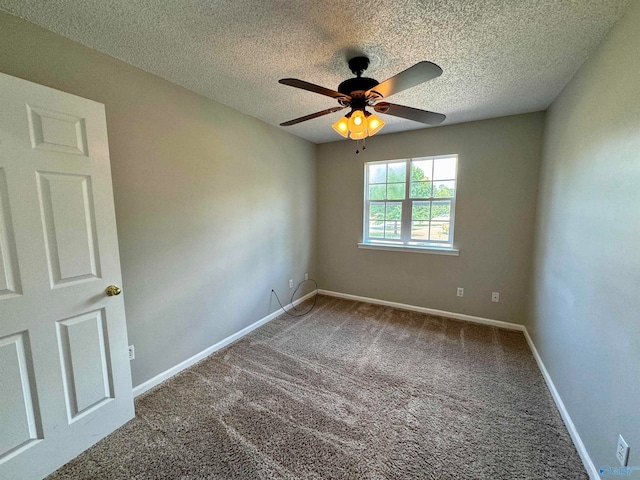 carpeted empty room featuring a textured ceiling and ceiling fan