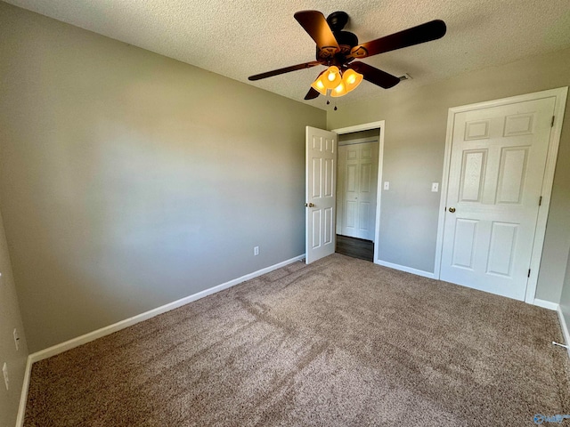 unfurnished bedroom featuring a textured ceiling, ceiling fan, and carpet floors