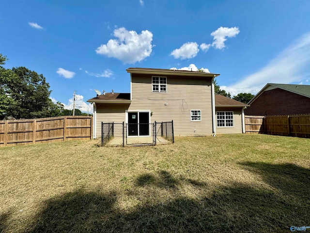 back of property featuring a lawn