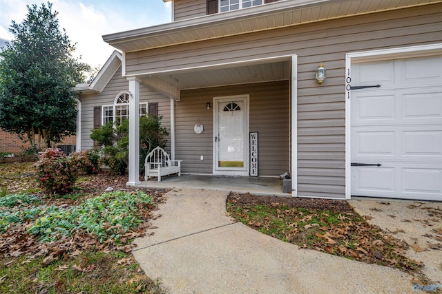 entrance to property with a porch and a garage