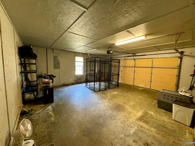 garage featuring electric panel and a garage door opener