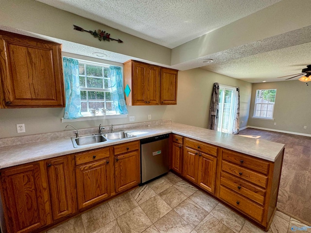 kitchen with ceiling fan, dishwasher, sink, and a textured ceiling