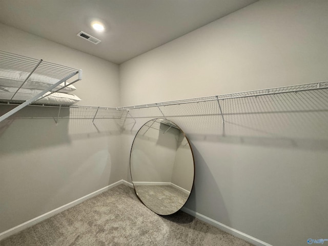 walk in closet featuring visible vents and carpet floors