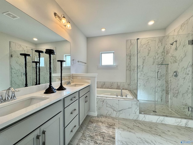 full bathroom with a marble finish shower, marble finish floor, a garden tub, and a sink