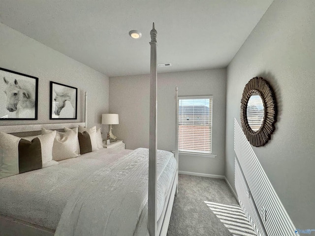 carpeted bedroom featuring visible vents and baseboards