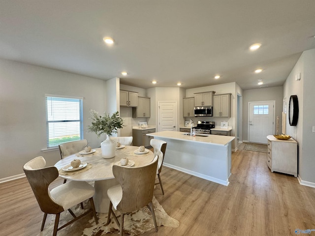 dining area featuring recessed lighting, light wood-type flooring, baseboards, and a healthy amount of sunlight