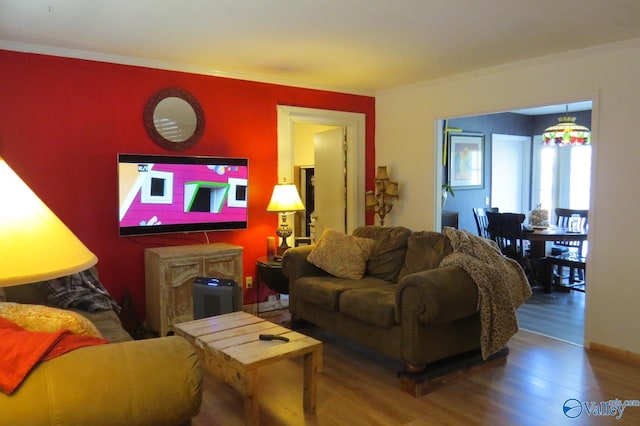 living room with crown molding and hardwood / wood-style floors