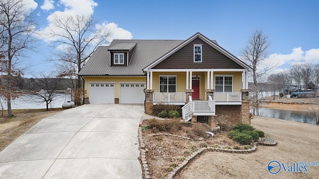 craftsman-style house featuring a garage, a water view, and a porch