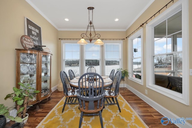 dining space with crown molding and dark hardwood / wood-style floors