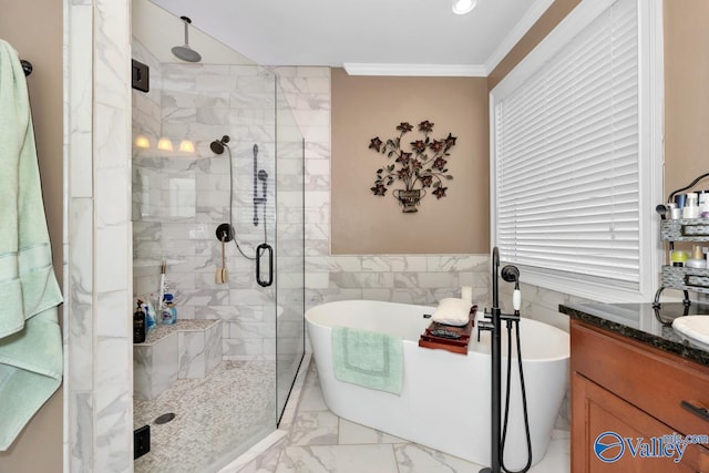 bathroom with crown molding, separate shower and tub, tile walls, and vanity