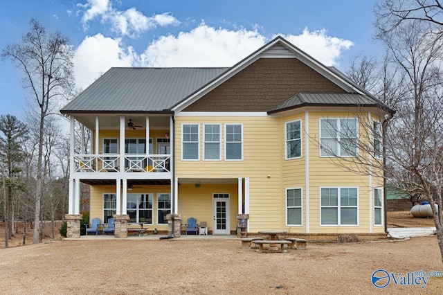 rear view of house featuring ceiling fan, a patio, and a balcony