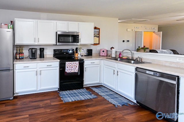 kitchen with sink, appliances with stainless steel finishes, dark hardwood / wood-style floors, and white cabinets