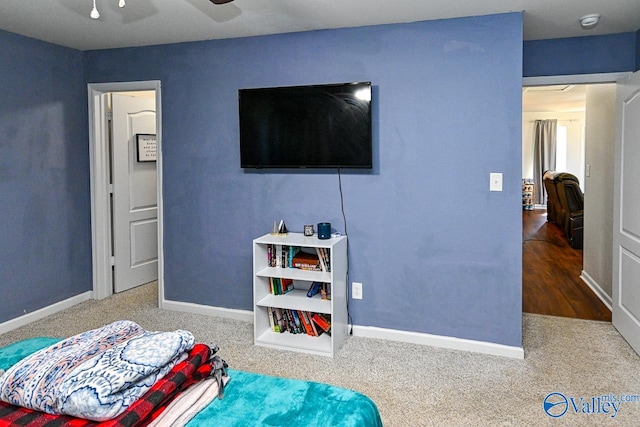 bedroom with wood-type flooring and ceiling fan