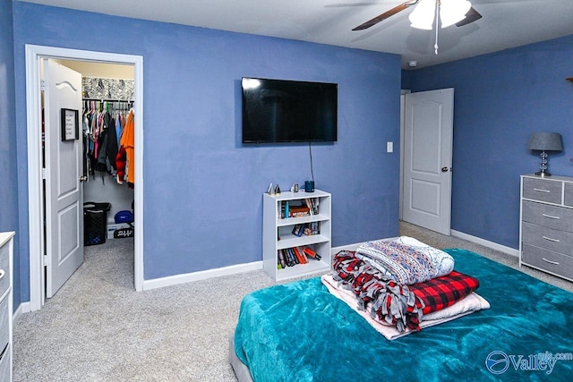 carpeted bedroom featuring a closet, ceiling fan, and a spacious closet