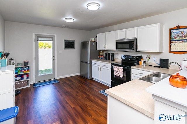 kitchen with white cabinets, stainless steel appliances, dark wood-type flooring, and sink