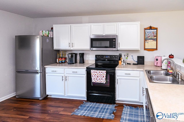 kitchen with sink, white cabinets, stainless steel appliances, and dark hardwood / wood-style flooring