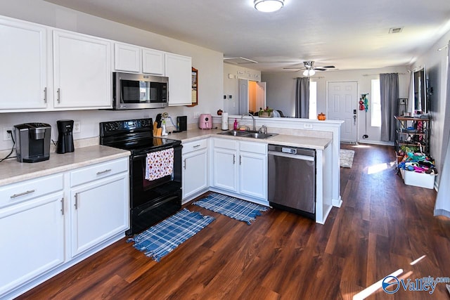 kitchen with dark hardwood / wood-style floors, kitchen peninsula, stainless steel appliances, sink, and white cabinetry