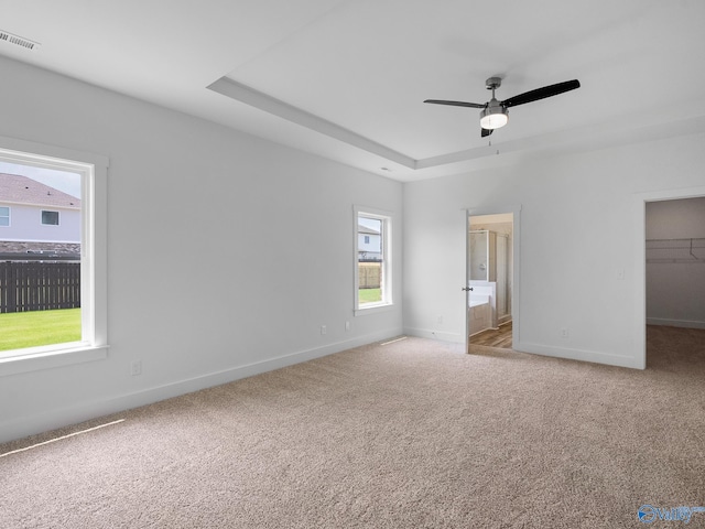 unfurnished bedroom featuring ceiling fan, light carpet, and multiple windows