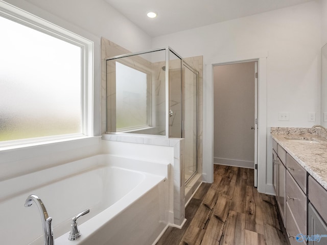 bathroom featuring vanity, hardwood / wood-style flooring, and separate shower and tub