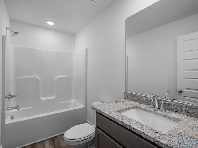 full bathroom featuring vanity, washtub / shower combination, wood-type flooring, and toilet