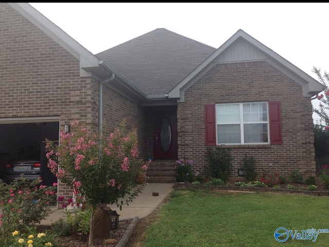 view of front of house with a garage and a front yard