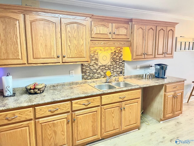 kitchen featuring sink, light wood-type flooring, tasteful backsplash, and ornamental molding