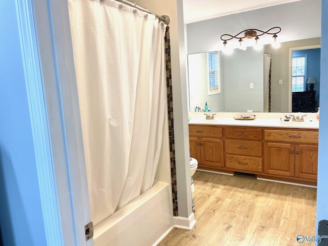 full bathroom featuring vanity, toilet, shower / tub combo, and wood-type flooring