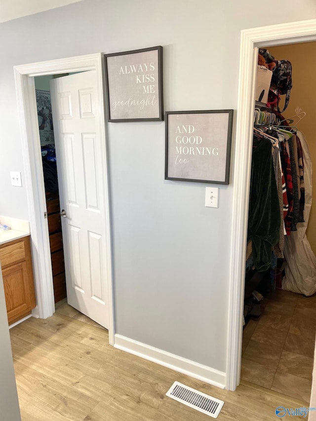 hallway with light wood-type flooring